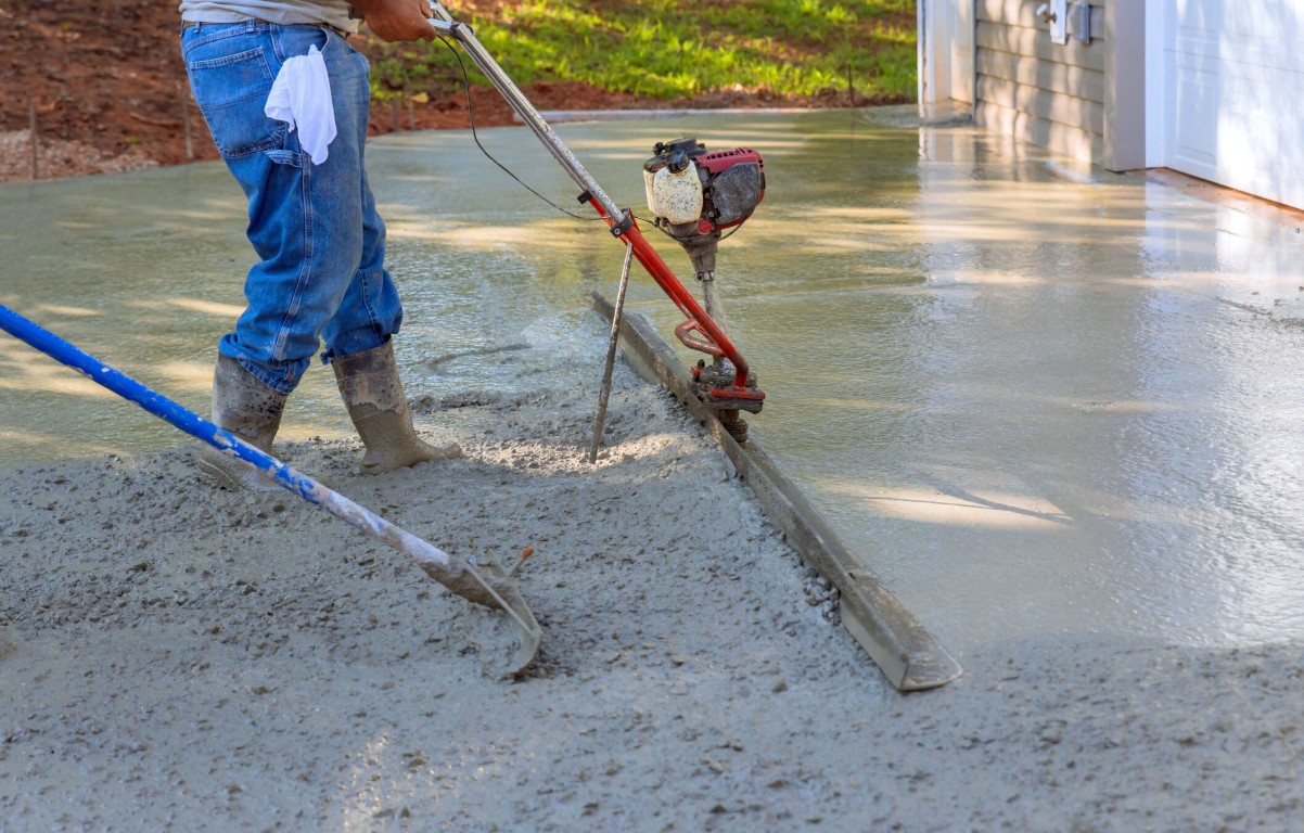 Professional screeding of concrete walkway surface